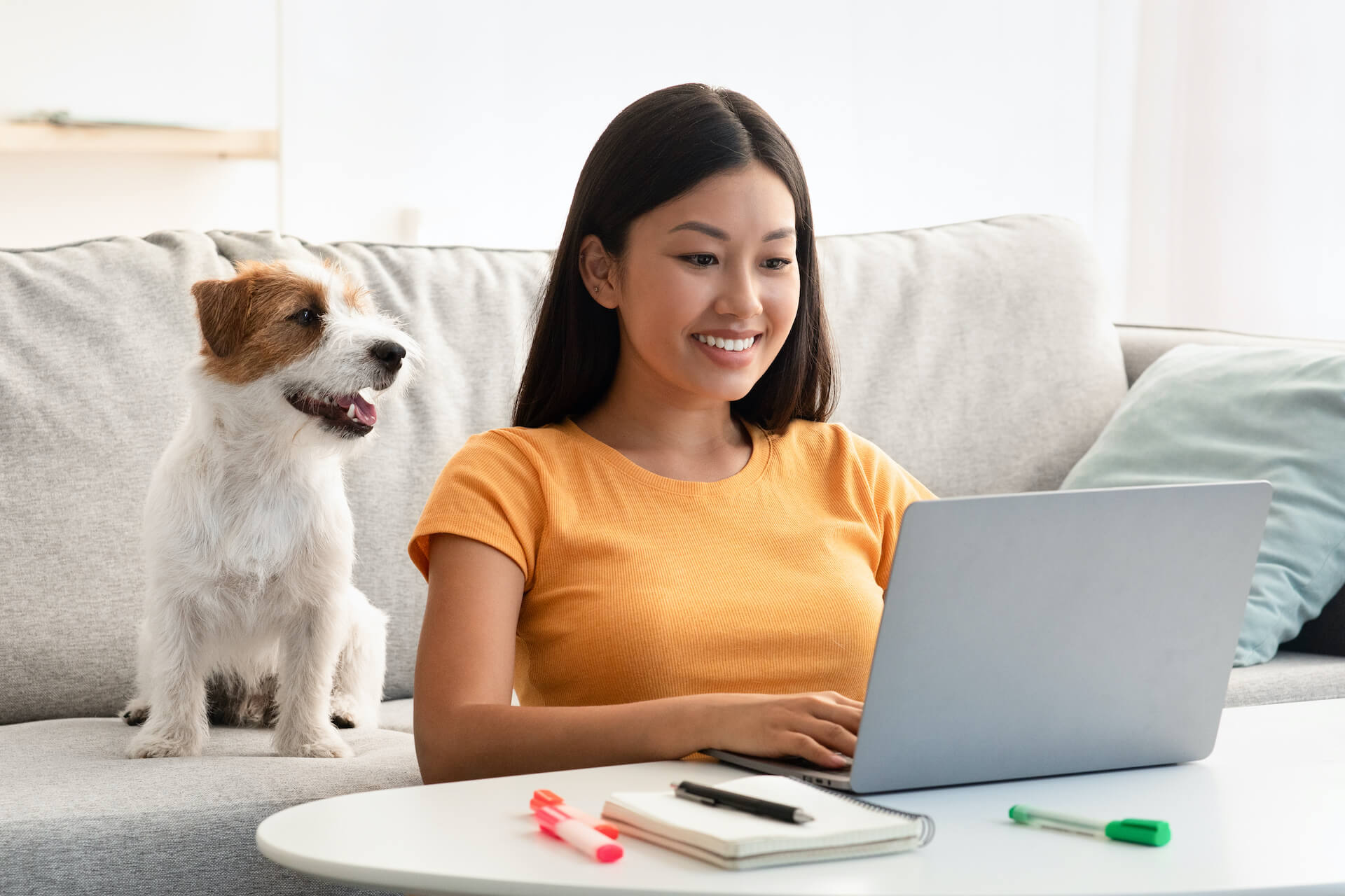 joyful-asian-lady-surfing-on-internet-cute-puppy-2022-12-16-08-55-57-utc